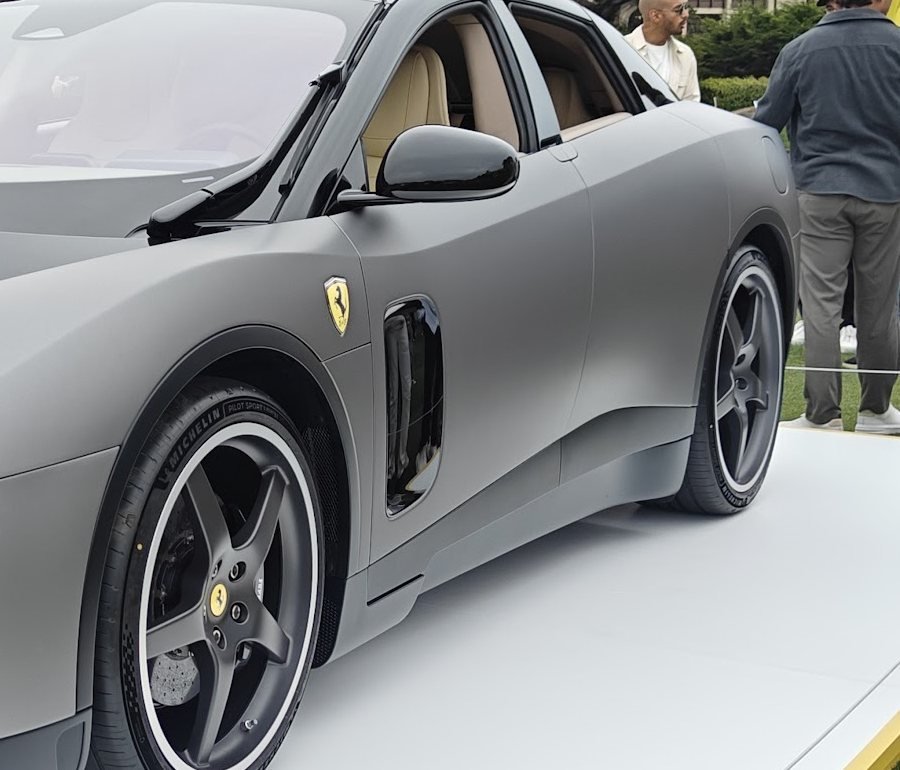 Detail view of the Ferrari Luce's side profile showing the Prancing Horse badge, side intake and large alloy wheel