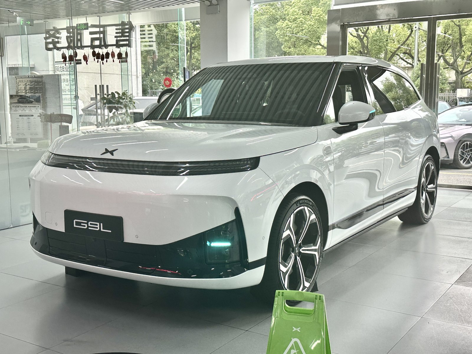 White XPeng G9L electric flagship SUV at an XPeng showroom