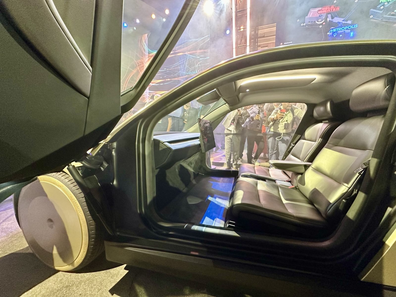 Tesla Cybercab robotaxi with butterfly doors, front three-quarter view