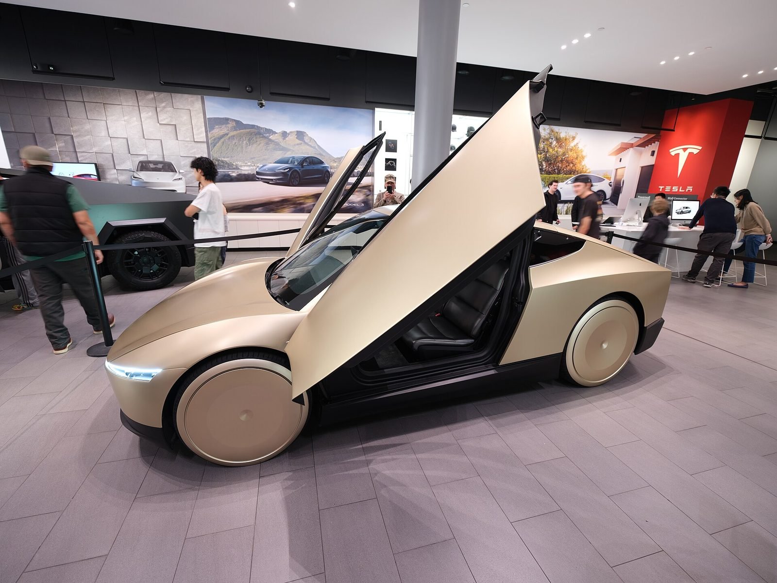 A Tesla Cybercab with its doors open on display inside a Tesla showroom