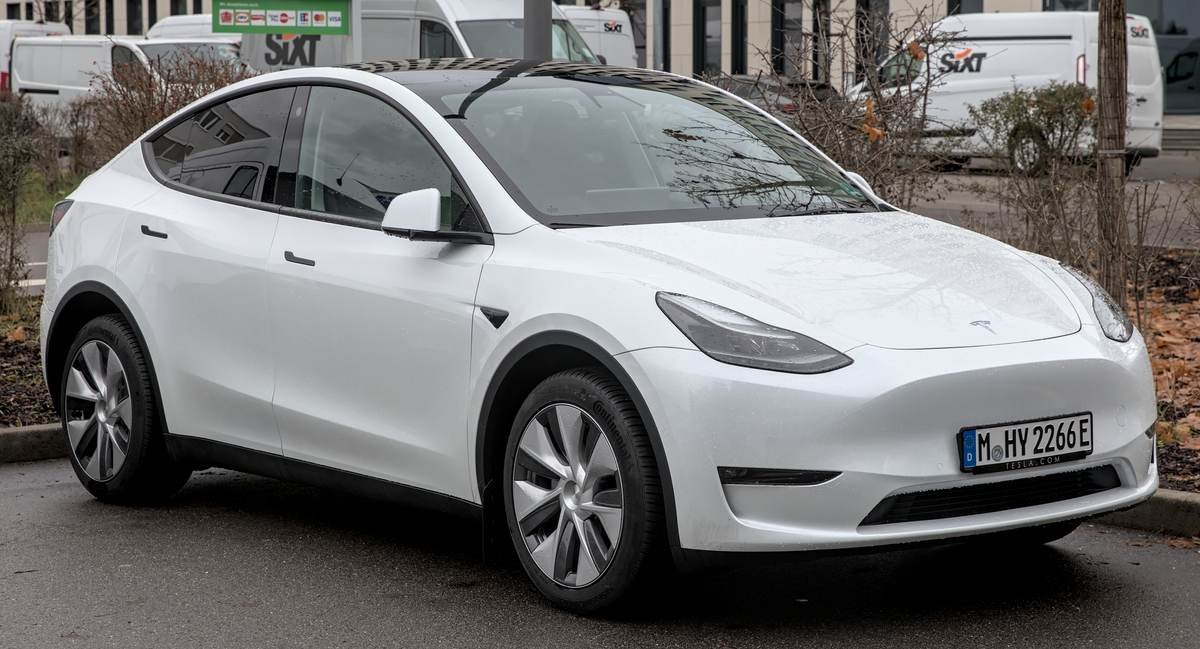 White Tesla Model Y front three-quarter view